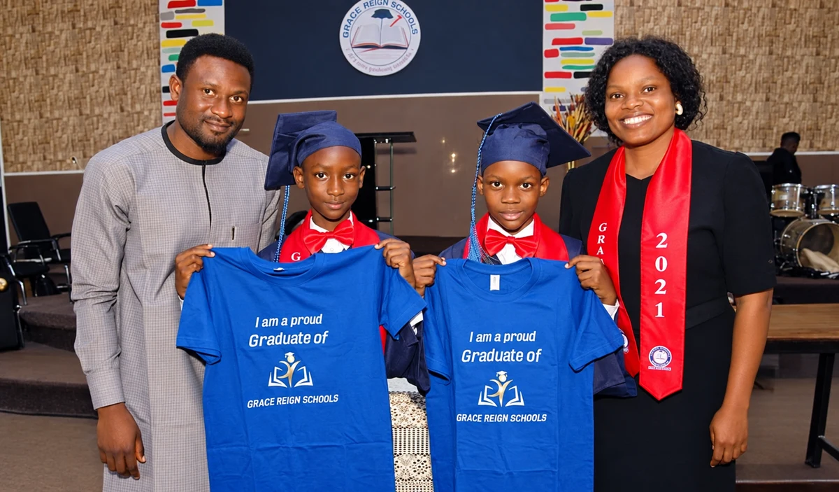 Grace Reign Schools graduates with adults at their graduation